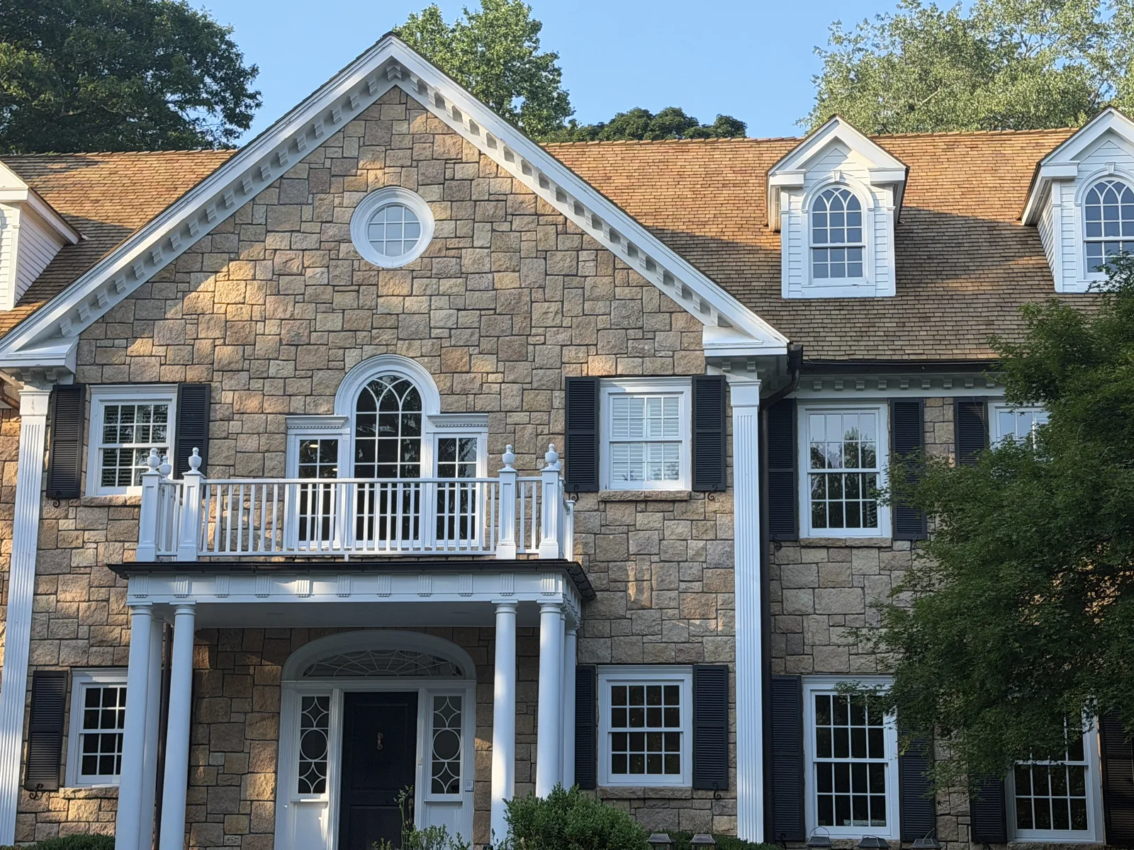 Cedar shake roof with arched gable dormers on a Connecticut colonial